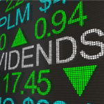 stock market ticker screen with the word "dividends" appearing in large text. discounted dividend stocks
